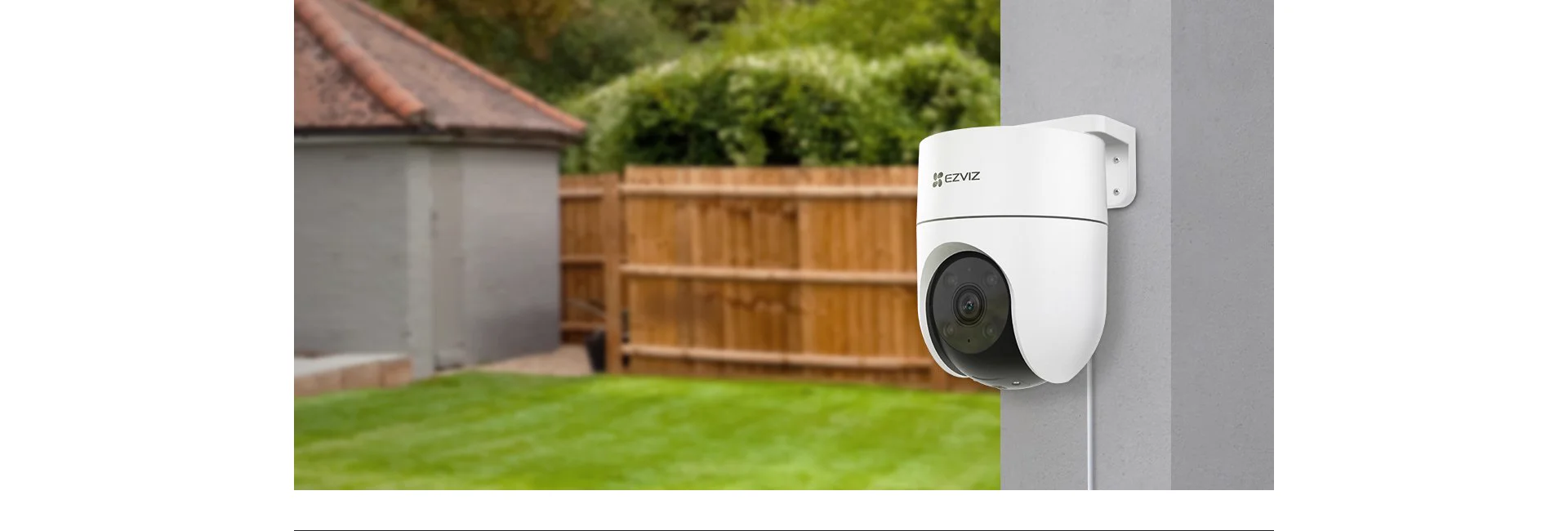 EZVIZ H8c 2MP camera mounted on outdoor wall in a garden